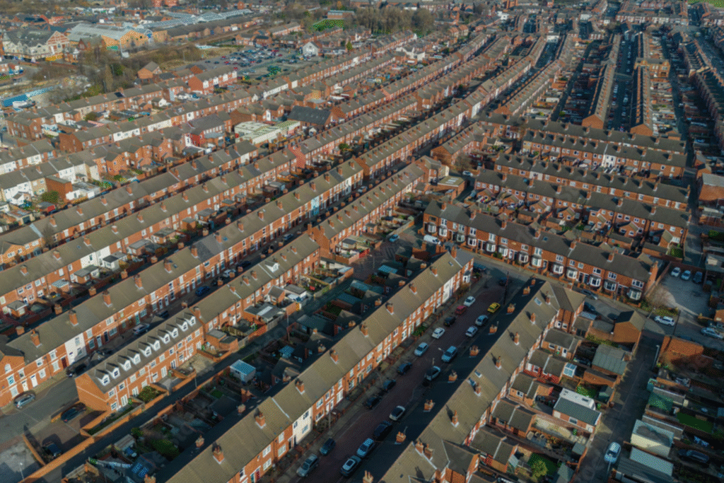 Aerial view of residential neighborhood in Wakefield, showcasing rows of terraced houses and surrounding streets, highlighting local construction potential for renovations and extensions.