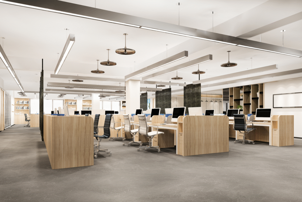 Modern office interior featuring wooden desks with computers, ergonomic chairs, and open workspaces, emphasizing quality design for functional office fit outs by Solved Construction in Wakefield.